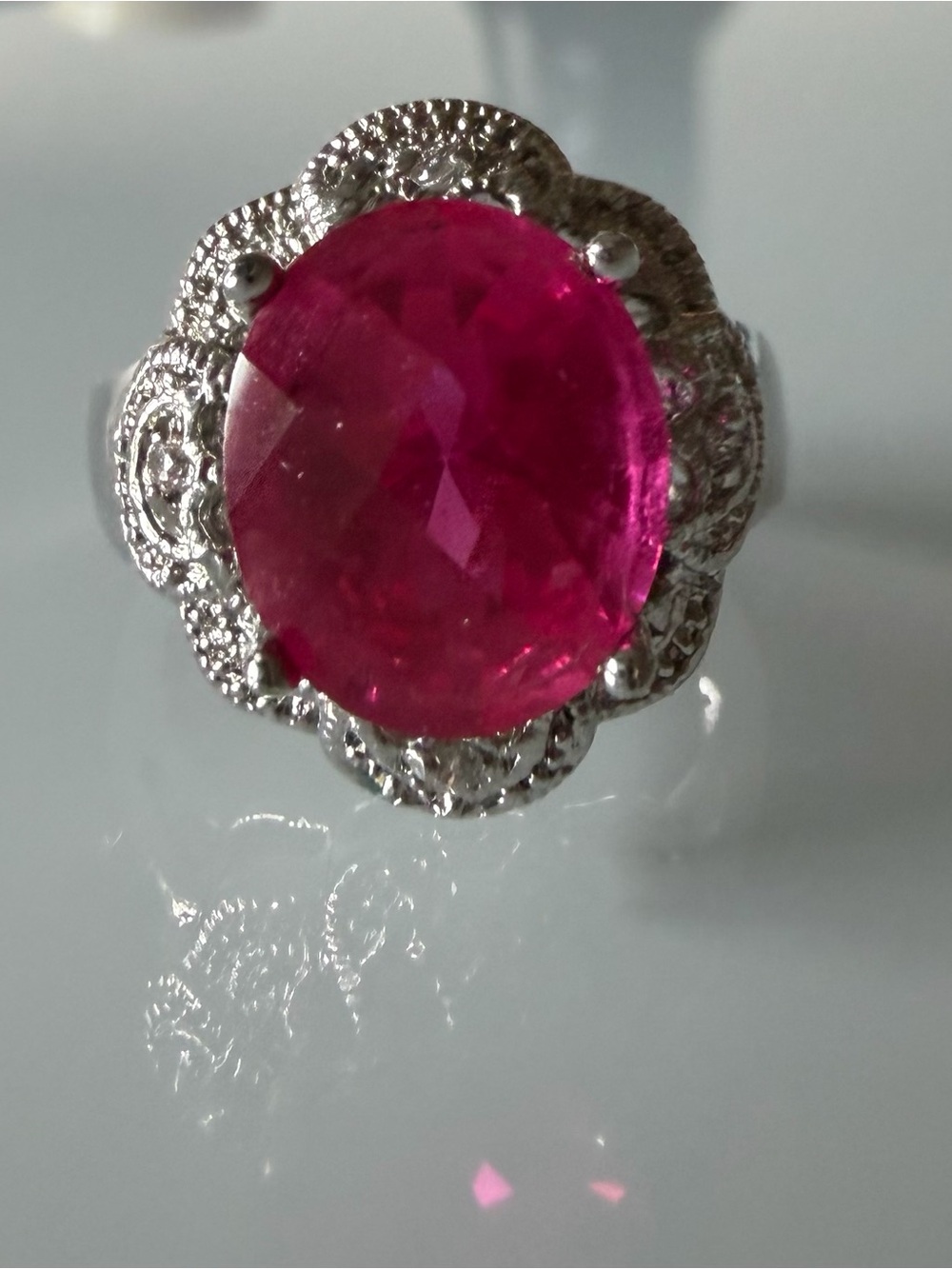 Vintage Ruby ring in silver tone halo setting.